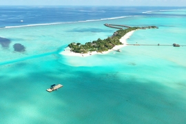In the lower left corner of this photograph, researchers prepare a submersible device. “Together with our collaborators in the Maldives, we are designing, testing, building, and deploying submersible devices that, based simply on their geometry in relationship to the ocean waves and currents, promote sand accumulation in specific areas,” says associate professor Skylar Tibbits.