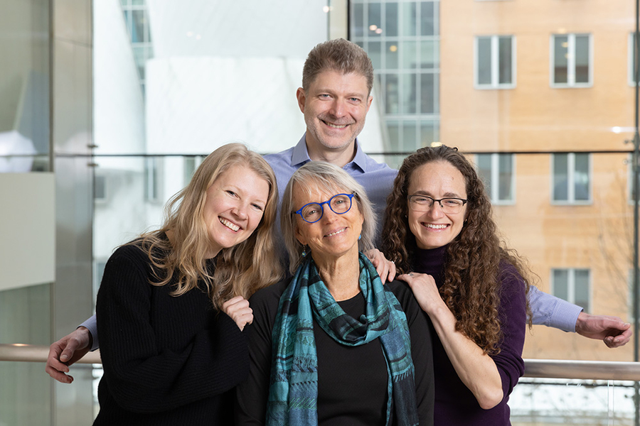 Group photo of four smiling scientists